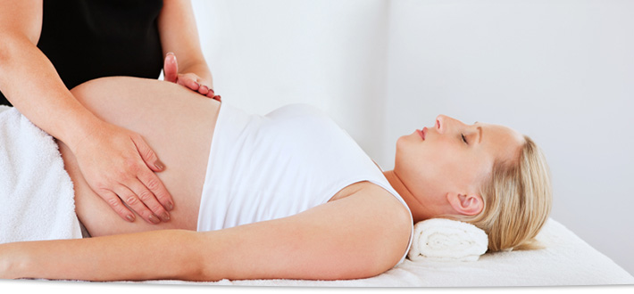 Massage Therapist performing a Pregnancy Massage